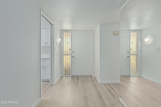 6051 E Ensenada St, Mesa, AZ 85205 - entryway with a textured ceiling, light wood finished floors, and baseboards
