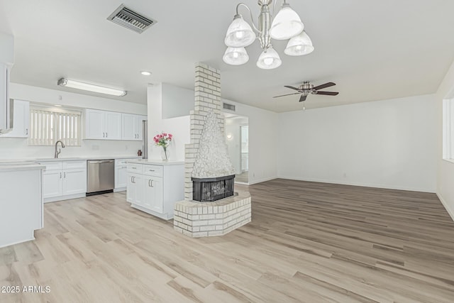 6051 E Ensenada St, Mesa, AZ 85205 - kitchen featuring stainless steel dishwasher, open floor plan, a ceiling fan, light countertops, and light wood-style floors