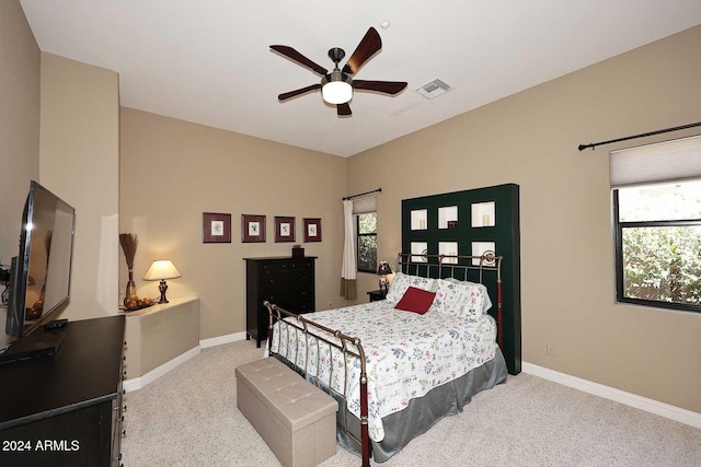 bedroom with ceiling fan and light colored carpet