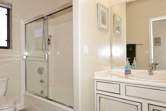 full bathroom with vanity, toilet, and enclosed tub / shower combo