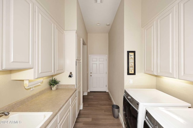 washroom featuring cabinets, washer and dryer, sink, and dark wood-type flooring