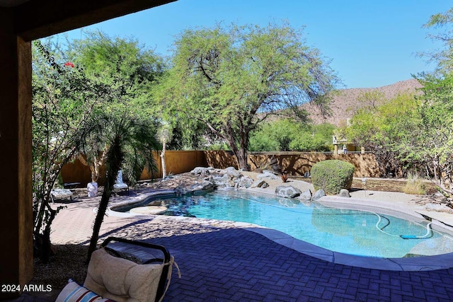 view of swimming pool featuring a mountain view and a patio area