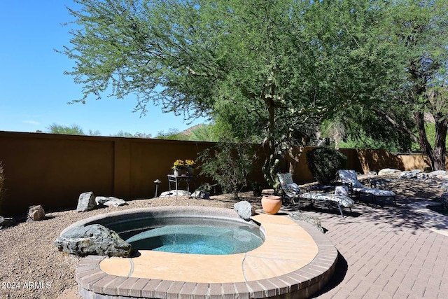 view of swimming pool with an in ground hot tub and a patio