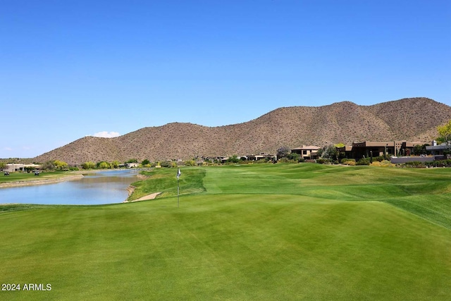 surrounding community with a yard and a water and mountain view