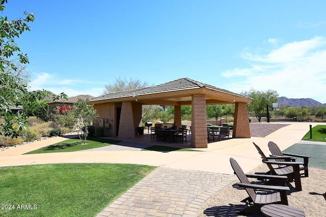 view of community featuring a gazebo, a patio area, a mountain view, and a lawn