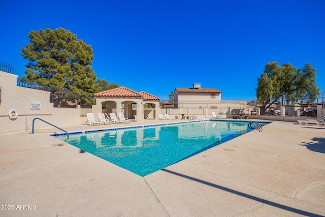 pool with a patio area, fence, and a gazebo