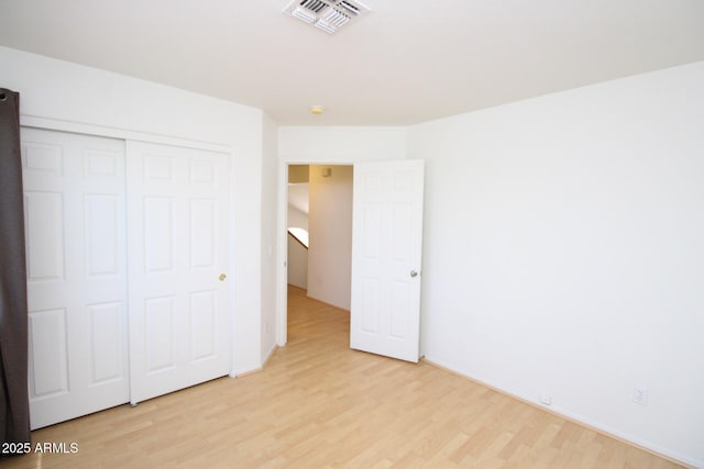 17606 N 17th Pl Unit 1096, Phoenix, AZ 85022 - unfurnished bedroom featuring light wood finished floors and a closet