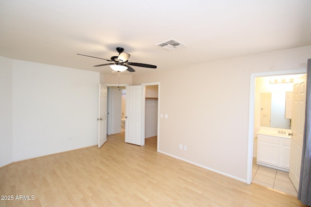 17606 N 17th Pl Unit 1096, Phoenix, AZ 85022 - unfurnished bedroom with light wood-style flooring, a spacious closet, ensuite bath, a closet, and ceiling fan