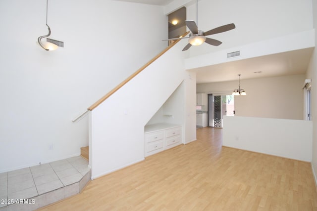 17606 N 17th Pl Unit 1096, Phoenix, AZ 85022 - unfurnished living room with a ceiling fan, light wood finished floors, and a chandelier
