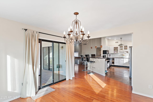 dining space with an inviting chandelier and light wood-type flooring