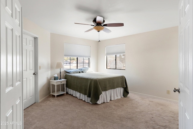 bedroom featuring light carpet and ceiling fan