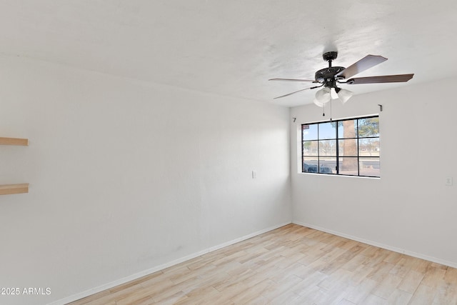 spare room featuring light hardwood / wood-style flooring and ceiling fan