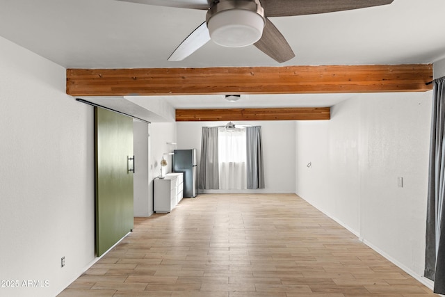 spare room featuring beamed ceiling, ceiling fan, and light hardwood / wood-style flooring