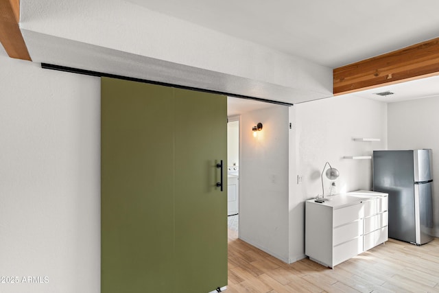 kitchen with stainless steel fridge and light wood-type flooring