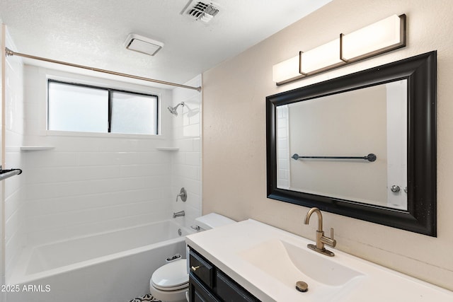 full bathroom with vanity, toilet, tiled shower / bath combo, and a textured ceiling