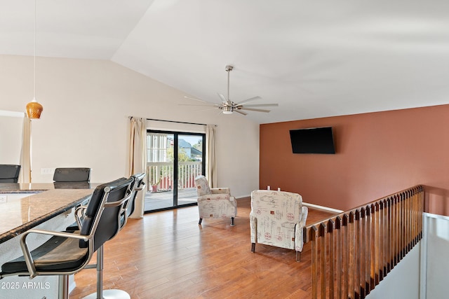 home office featuring vaulted ceiling, ceiling fan, and light hardwood / wood-style floors