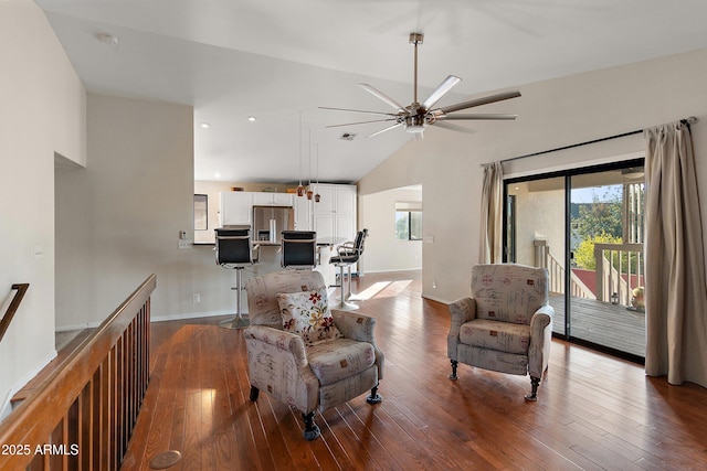 living room with lofted ceiling, hardwood / wood-style floors, and ceiling fan