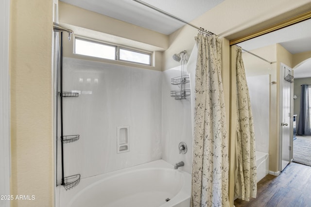 bathroom with wood finished floors and shower / bath combo