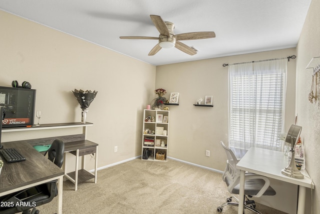 carpeted office space with baseboards and ceiling fan