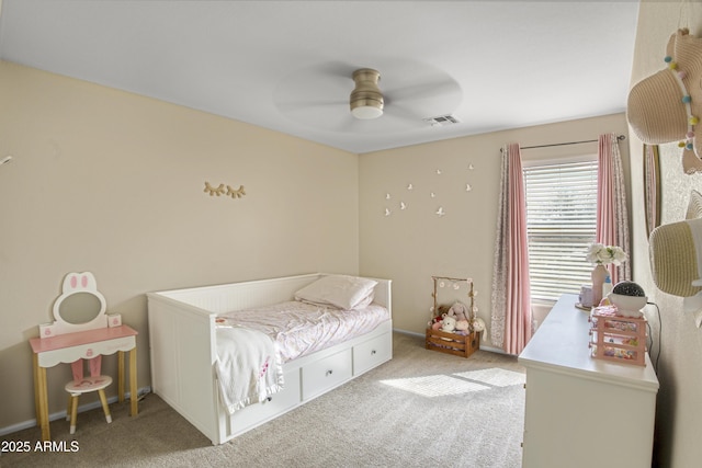 bedroom with visible vents, light colored carpet, and a ceiling fan