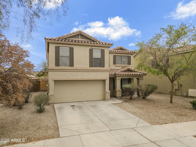 mediterranean / spanish house with stucco siding, concrete driveway, an attached garage, and a tile roof