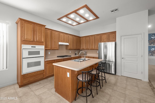 7145 E Cuernavaco Way, Gold Canyon, AZ 85118 - kitchen with a sink, light countertops, freestanding refrigerator, double oven, and gas cooktop