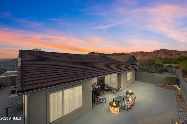 7145 E Cuernavaco Way, Gold Canyon, AZ 85118 - view of patio / terrace with an outdoor fire pit, a fenced backyard, and a mountain view