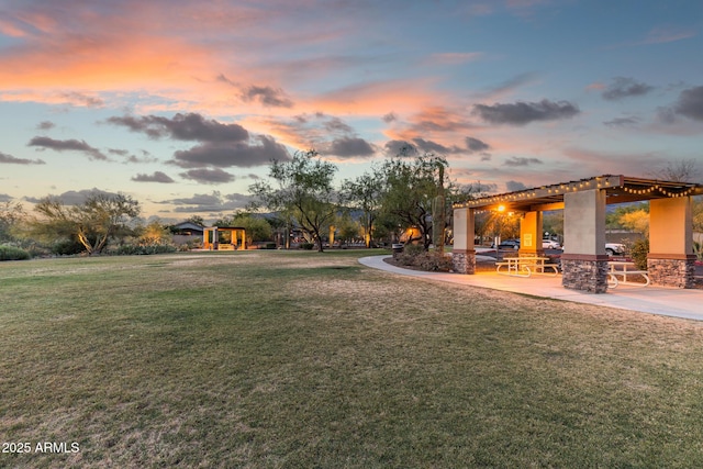 7145 E Cuernavaco Way, Gold Canyon, AZ 85118 - yard at dusk with a patio and playground community