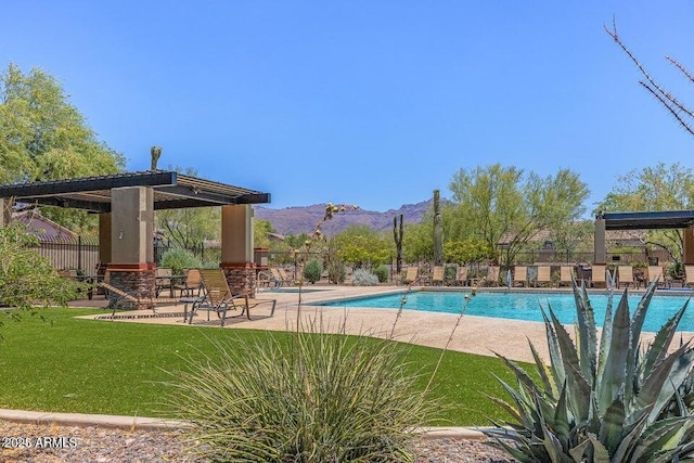 7145 E Cuernavaco Way, Gold Canyon, AZ 85118 - community pool featuring a patio, a mountain view, fence, and a lawn