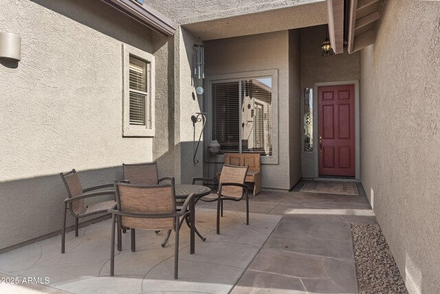 7145 E Cuernavaco Way, Gold Canyon, AZ 85118 - property entrance featuring a patio area, outdoor dining area, and stucco siding