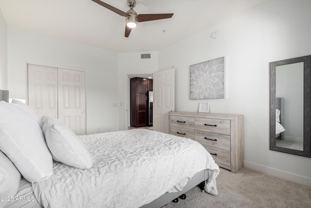 carpeted bedroom featuring ceiling fan and a closet