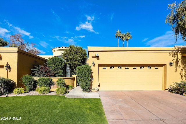 view of front facade with a front yard and a garage