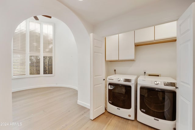 clothes washing area featuring separate washer and dryer, cabinets, ceiling fan, and light hardwood / wood-style floors