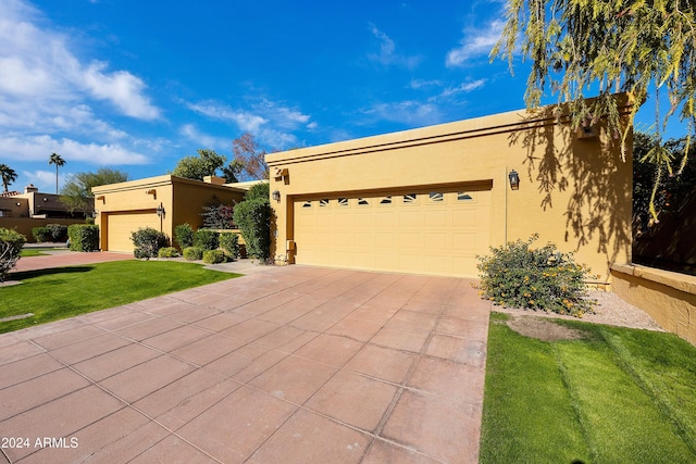 view of front of property featuring a garage and a front lawn