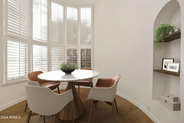 dining space with wood-type flooring