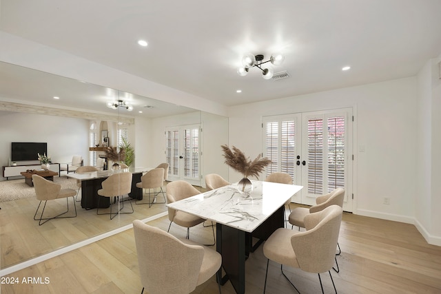 dining space with french doors and light hardwood / wood-style floors