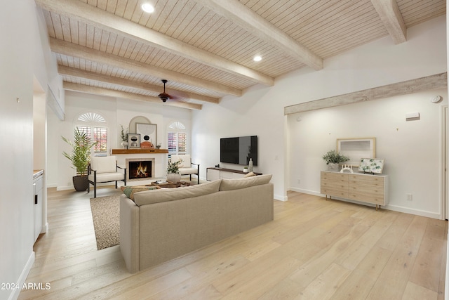 living room with ceiling fan, beamed ceiling, wood ceiling, and light wood-type flooring