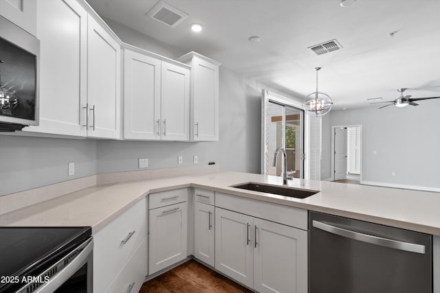 2511 W Queen Creek Rd Unit 116, Chandler, AZ 85248 - kitchen with appliances with stainless steel finishes, a sink, light countertops, white cabinetry, and ceiling fan