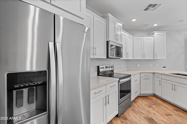 2511 W Queen Creek Rd Unit 116, Chandler, AZ 85248 - kitchen with stainless steel appliances, a sink, white cabinetry, light countertops, and recessed lighting