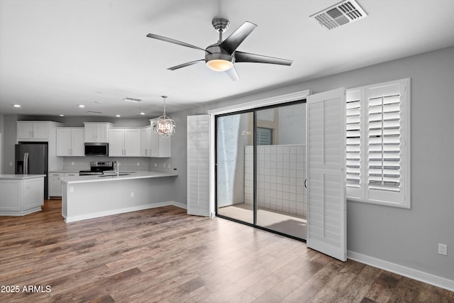 2511 W Queen Creek Rd Unit 116, Chandler, AZ 85248 - kitchen featuring appliances with stainless steel finishes, light countertops, baseboards, a sink, and recessed lighting