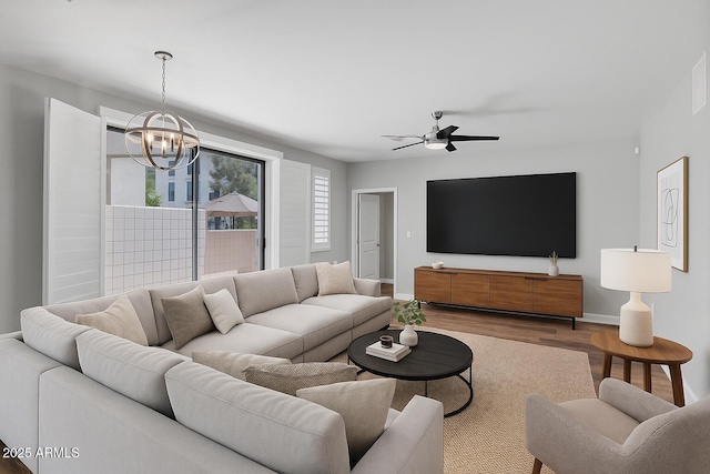 2511 W Queen Creek Rd Unit 116, Chandler, AZ 85248 - living area featuring a chandelier, wood finished floors, baseboards, and ceiling fan