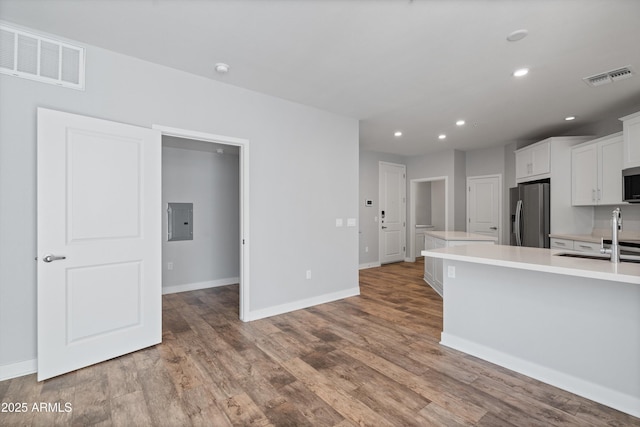 2511 W Queen Creek Rd Unit 116, Chandler, AZ 85248 - kitchen with stainless steel appliances, electric panel, light countertops, recessed lighting, and wood finished floors