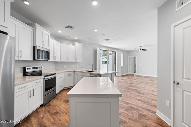 2511 W Queen Creek Rd Unit 116, Chandler, AZ 85248 - kitchen with stainless steel appliances, a peninsula, a sink, recessed lighting, and baseboards