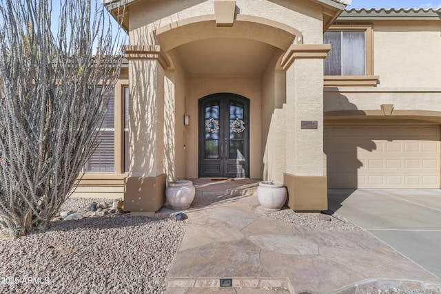 property entrance with a garage and french doors