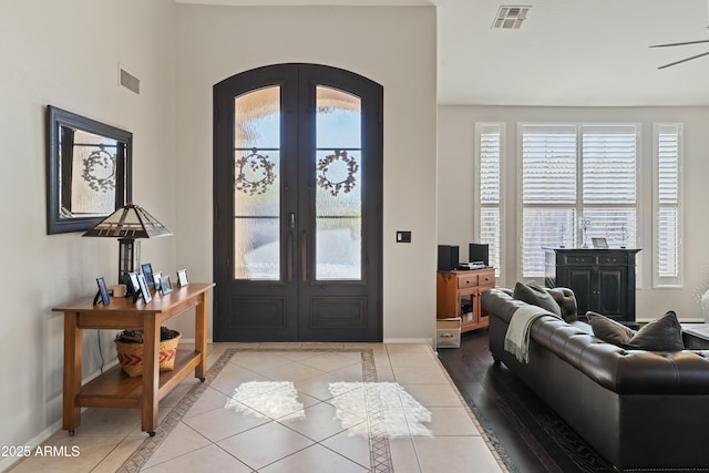 tiled entrance foyer featuring french doors and a wealth of natural light