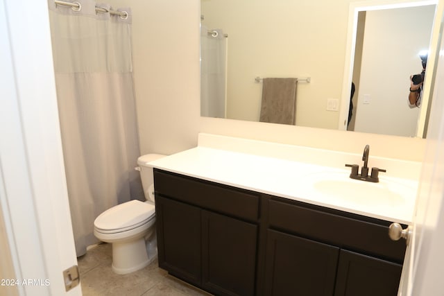 bathroom featuring vanity, a shower with curtain, toilet, and tile patterned floors