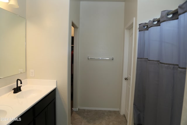 bathroom with vanity, tile patterned flooring, and walk in shower