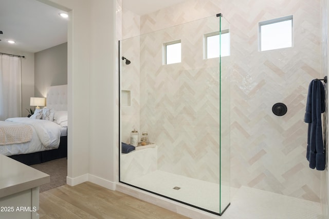 bathroom featuring hardwood / wood-style floors and tiled shower