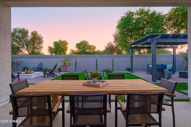 patio terrace at dusk featuring an outdoor living space with a fire pit