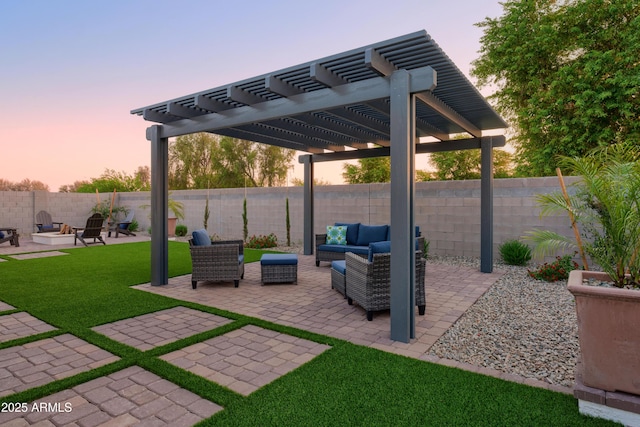 patio terrace at dusk featuring a yard and an outdoor hangout area